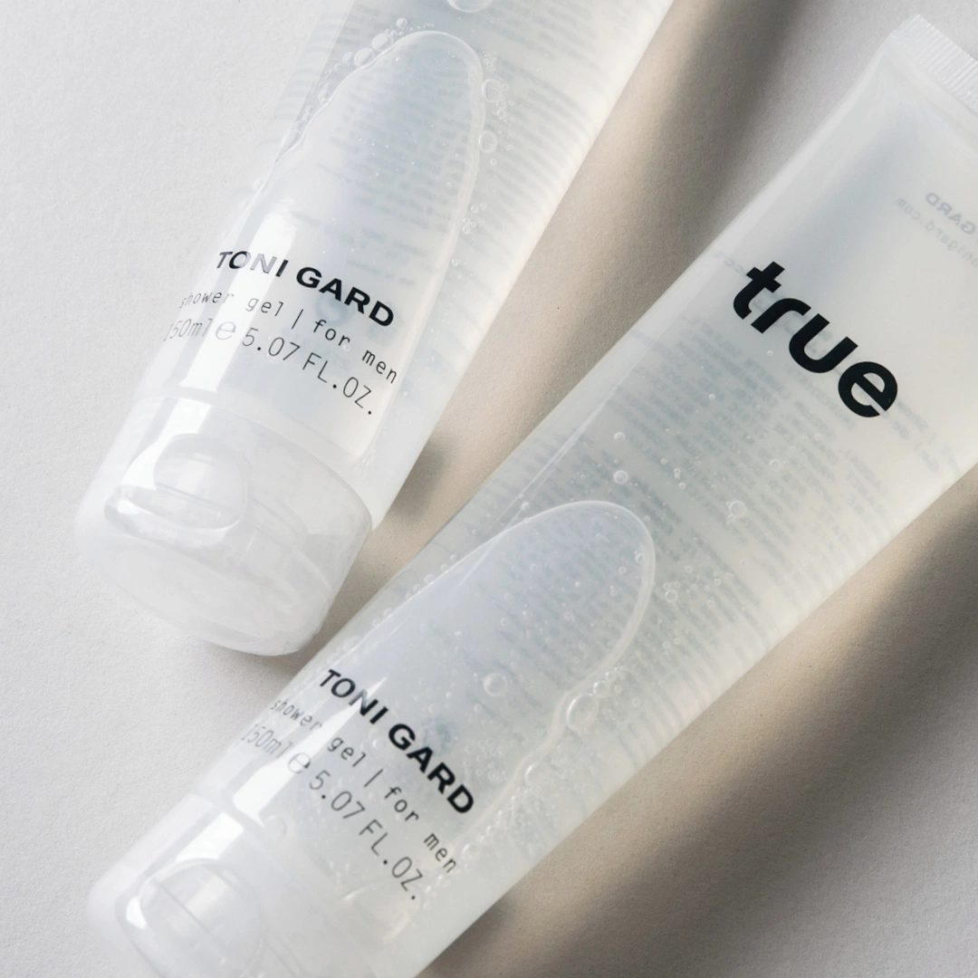 Zwei transparente Duschgel-Tuben mit der Aufschrift 'TONI GARD' und 'true'.