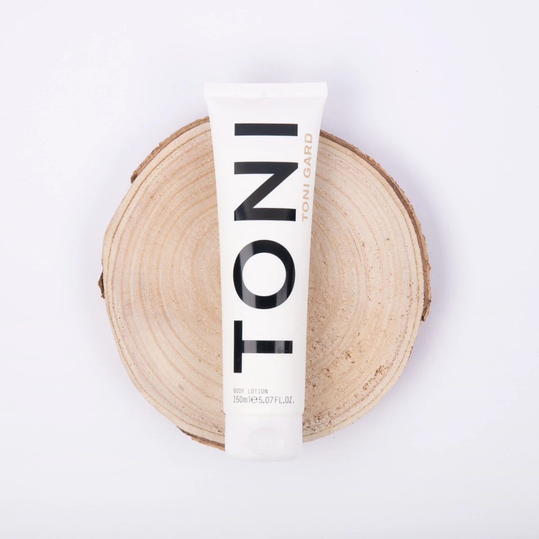 Toni Gard body lotion on wood slice, white background, product photography