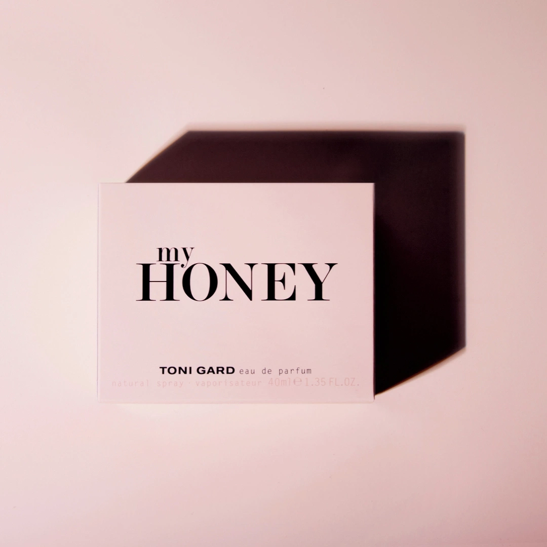 Product packaging with the words "my HONEY" and shadow on a pink background.