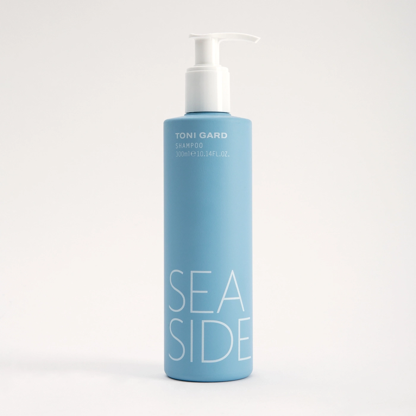 Blue shampoo bottle with white text 'SEA SIDE' and 'TONI GARD' on it.