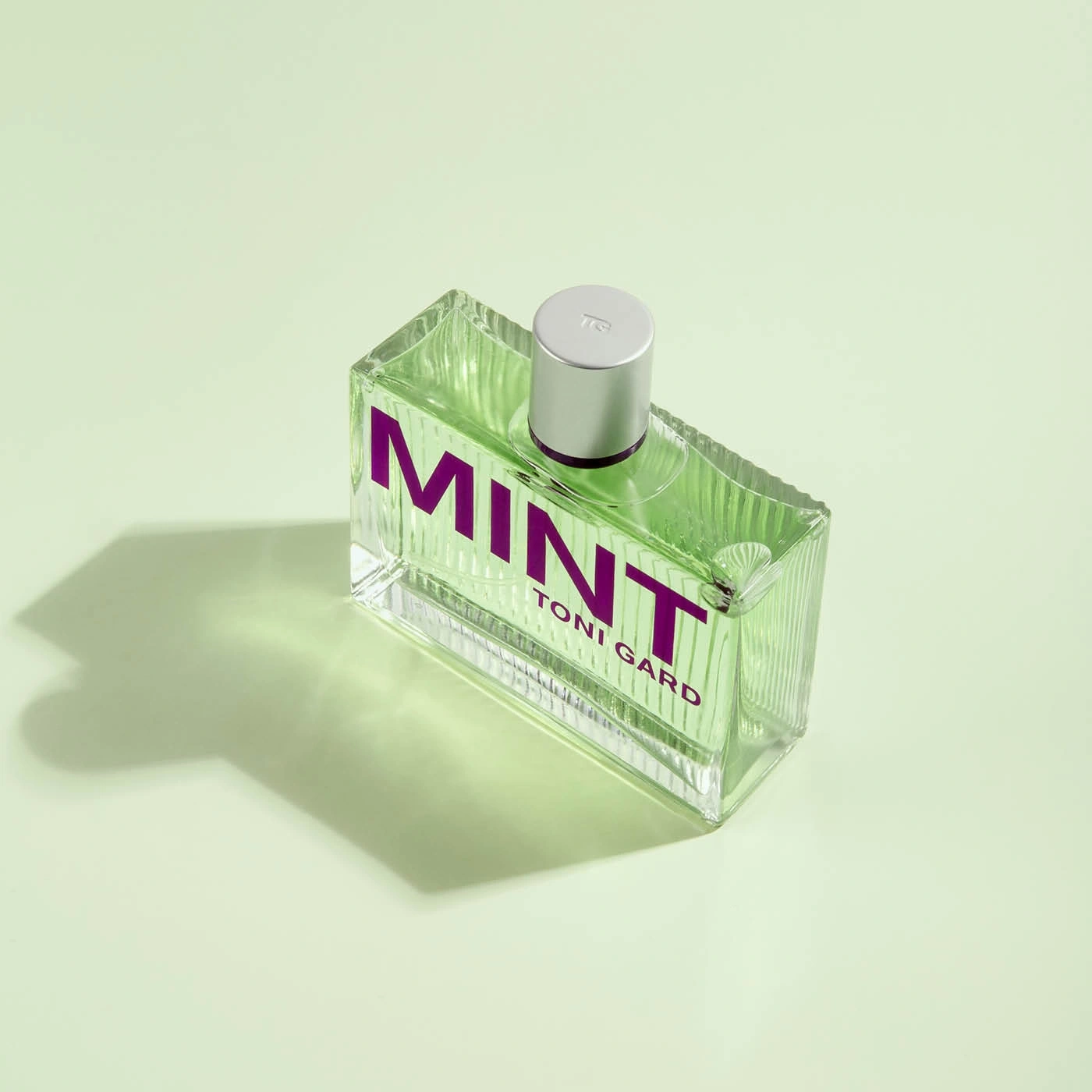 Toni Gard Mint perfume, green liquid, purple text, light green background